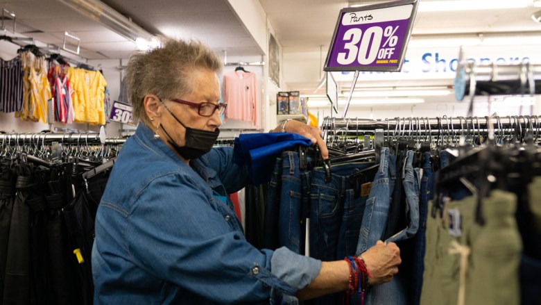 Sylvia Smith looks at a pair of jeans to purchase at Falla's