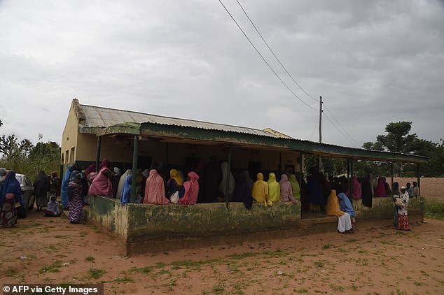 This photo, from September last year, shows mothers with acute malnourished babies sitting on the floor and fences to be attended by health officials at Bini primary health clinic, Wamako district of Sokoto in northwest Nigeria