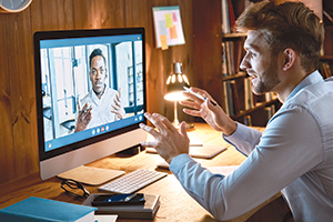 Remote workers interact via computer screen