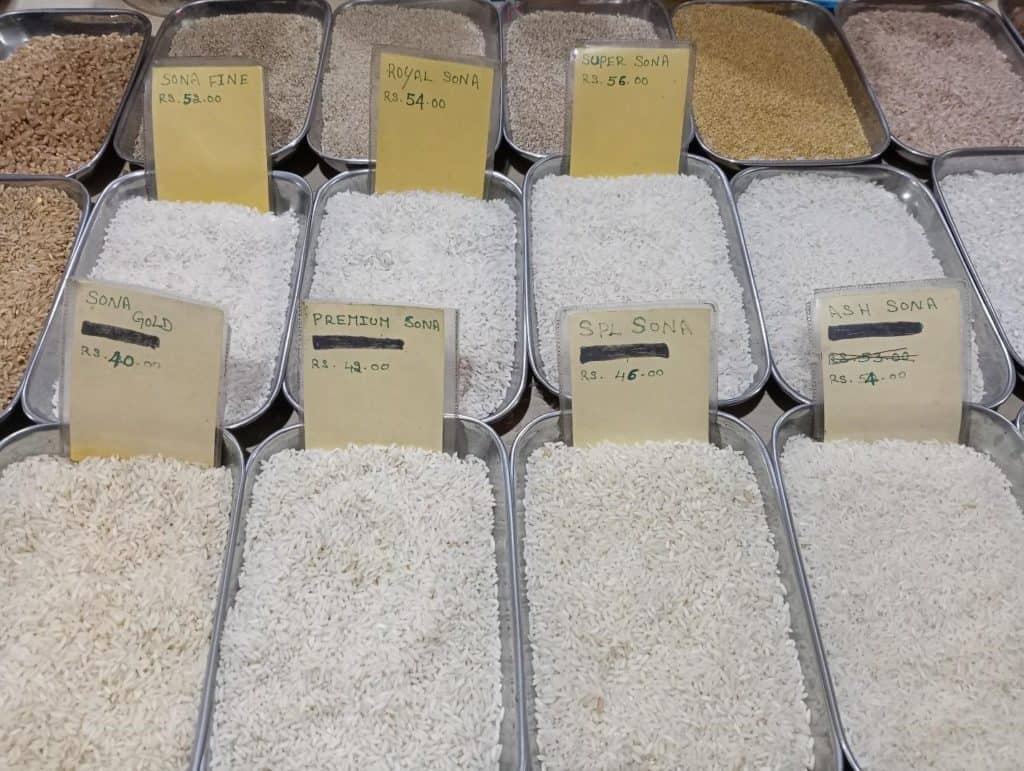 Different varieties of rice on sale at a supermarket with price rates on display