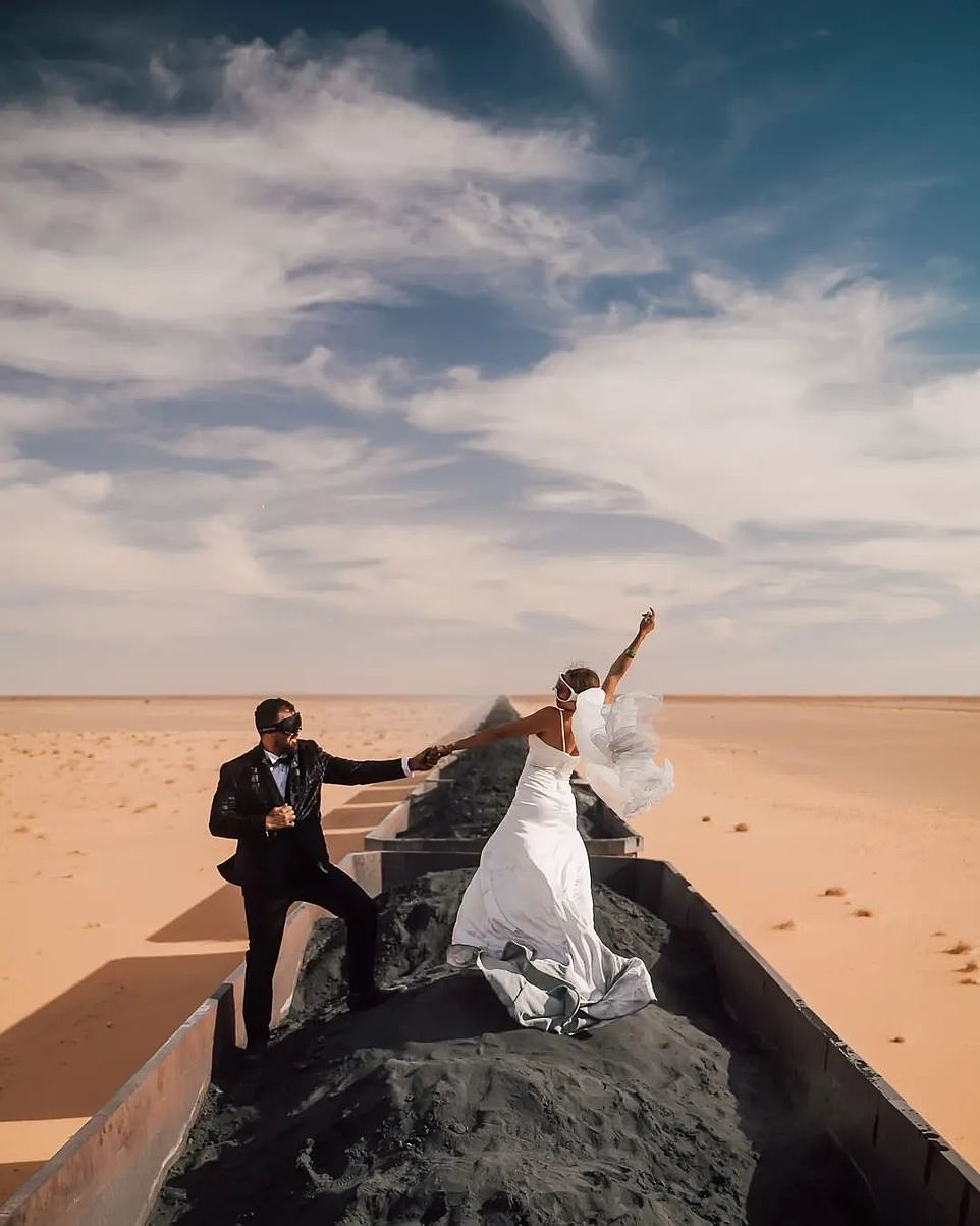The daredevil newlyweds, who wanted their honeymoon to 'be unique', climbed onto the heaviest, longest, and most dangerous freight train for the dirty 20-hour journey through the harsh conditions of the desert