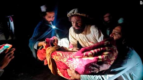 In this photo released by state-run news agency Bakhtar, Afghans evacuate the wounded following the quake in Paktika province, eastern Afghanistan.