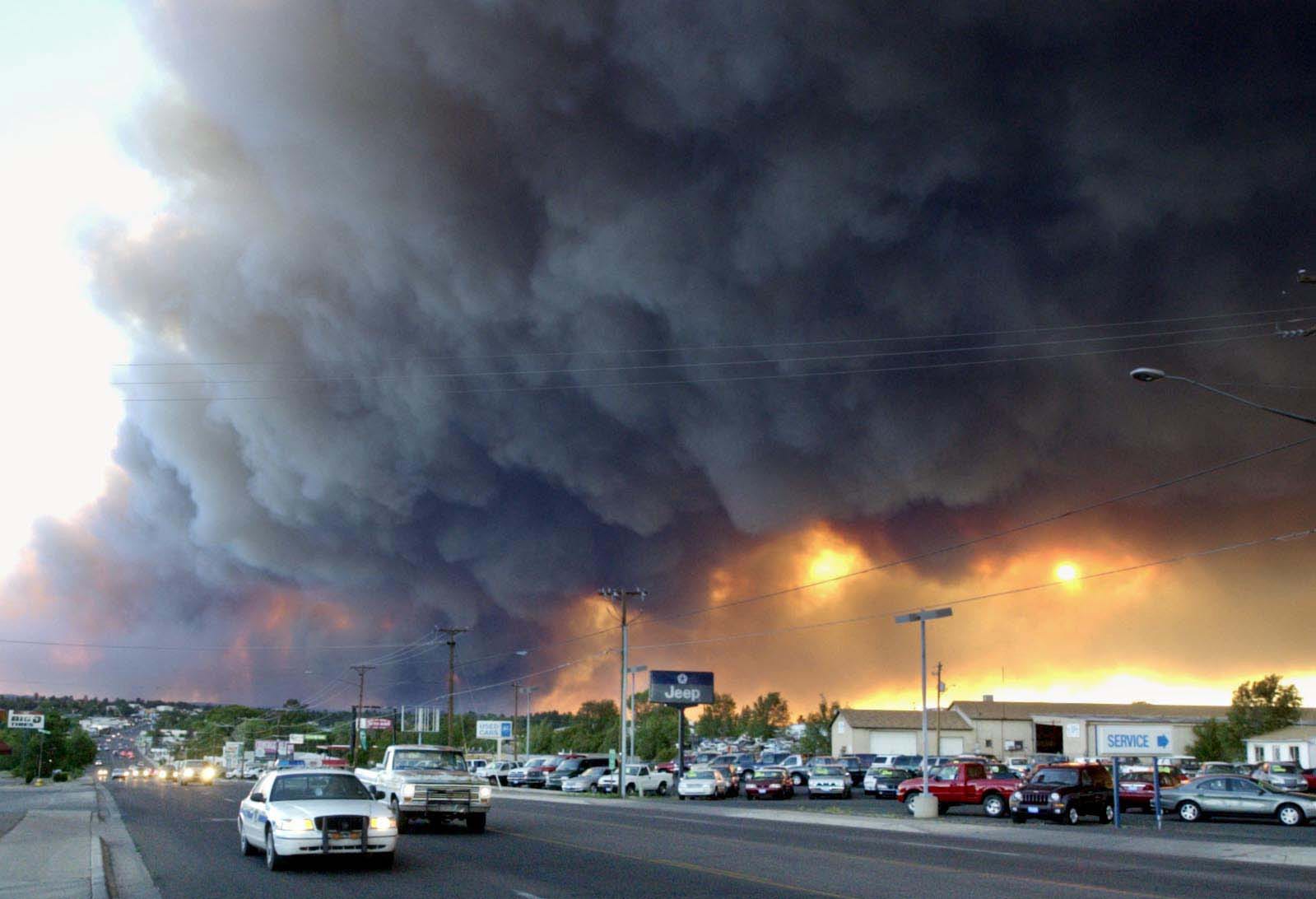 A smoke column rise from a "wall of fire" from the Rodeo Fire on June 22, 2002.