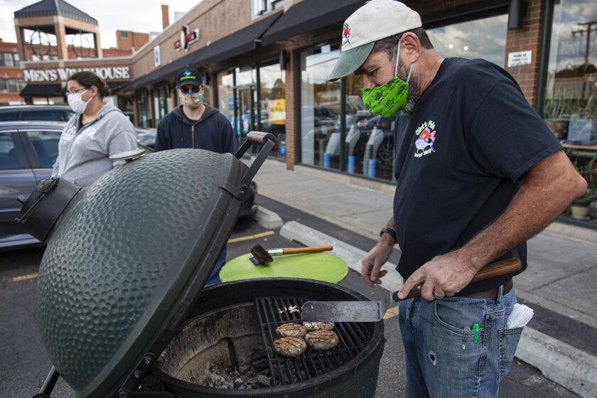 Owner Dirk Fucik prepares a Asian carp burger inside Dirk’s Fish and Gourmet Shop at 2070 N Clybourn Ave in Sheffield Neighbors, Thursday, Oct. 15, 2020.