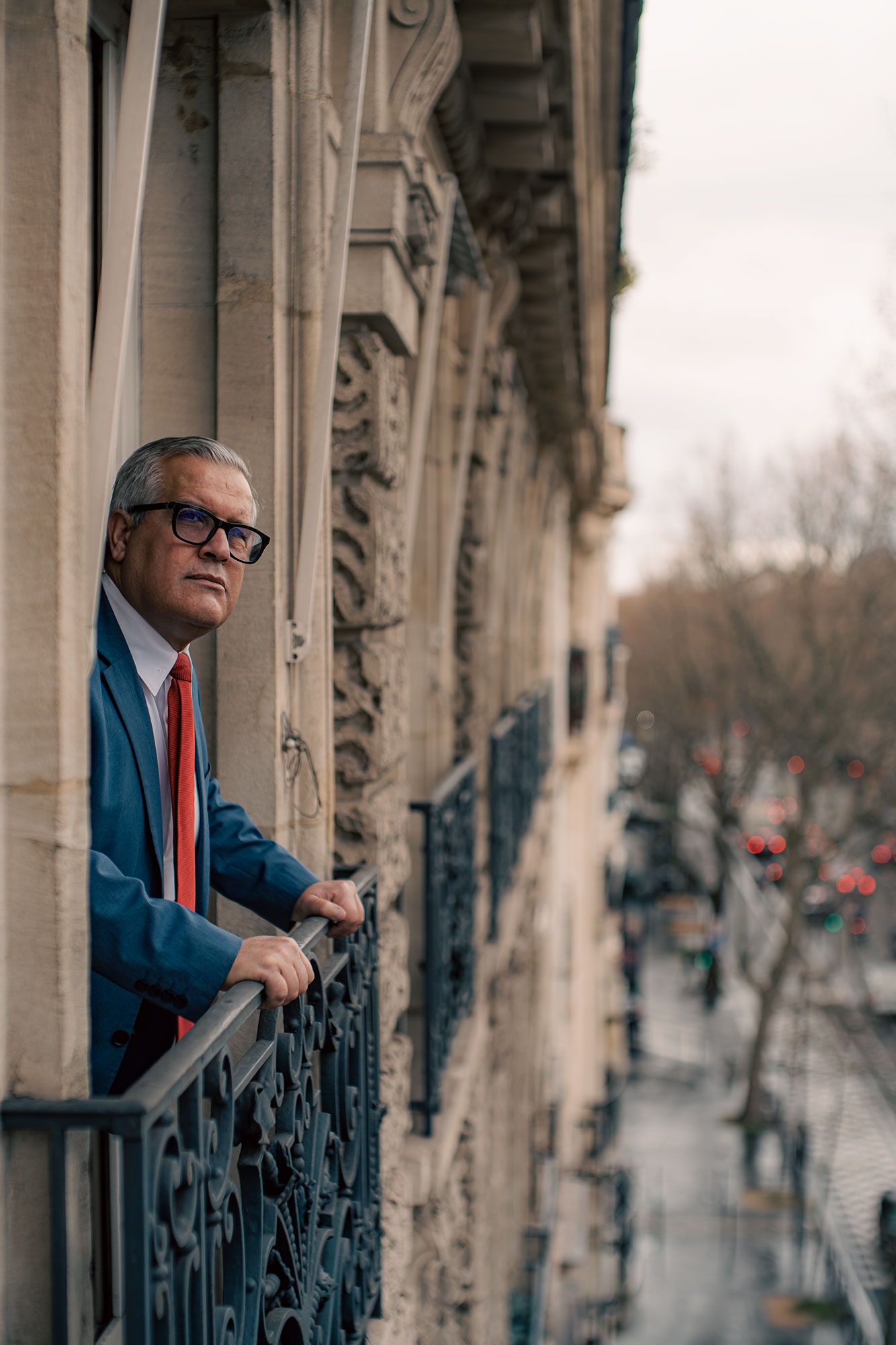 Image may contain Banister Handrail Railing Human Person Clothing Apparel Suit Coat and Overcoat