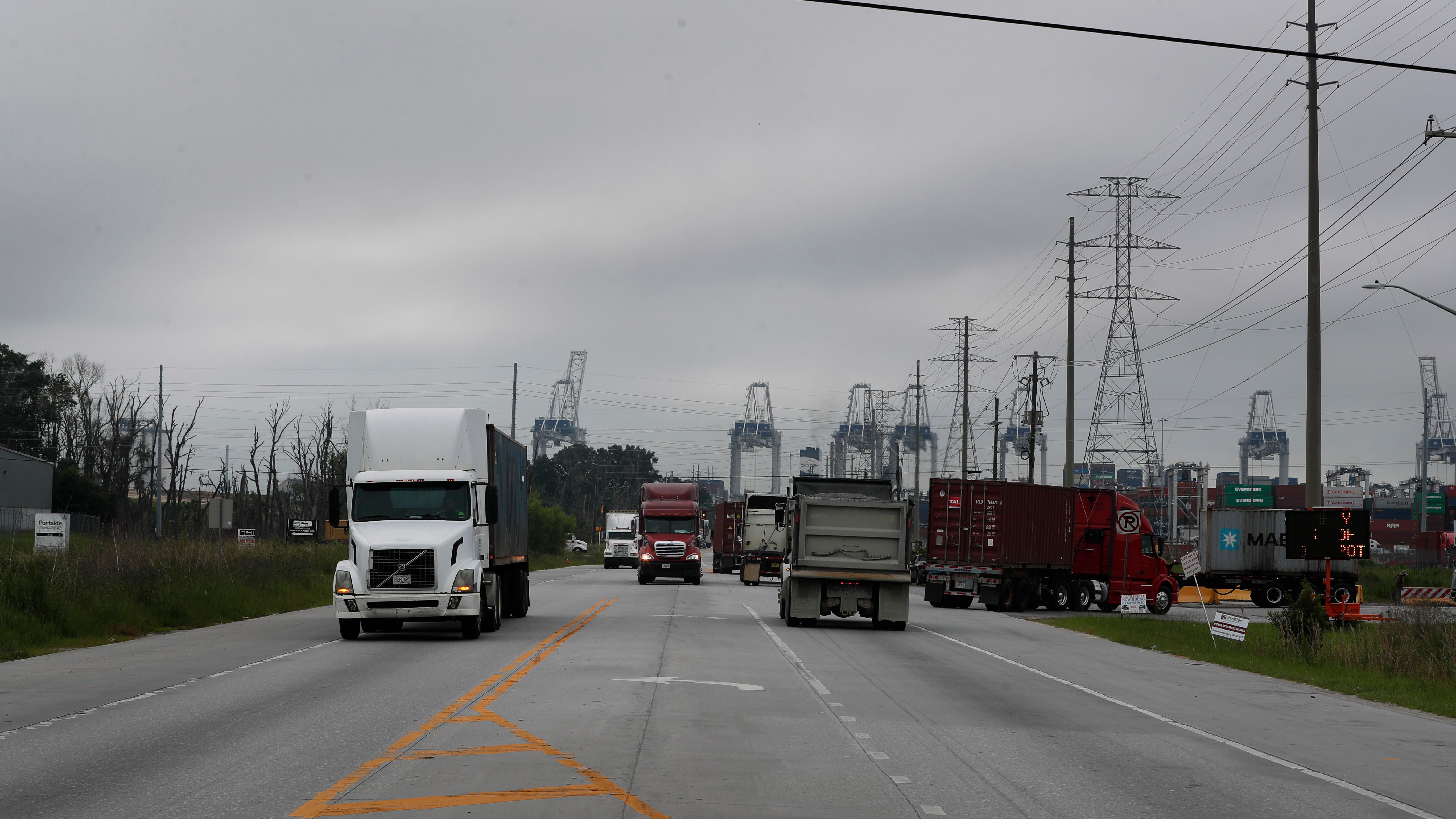 Trucks move along Grange Road in Port Wentworth. Grange road was once a residential area with homes lining the streets, now it's filled with traffic for the Ports and container lots.