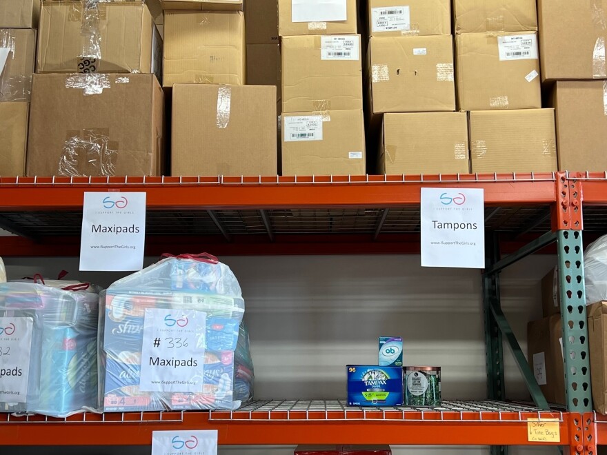 A shelf in a warehouse used by the nonprofit I Support The Girls is nearly empty of the tampon supply it keeps to distribute to people in need.