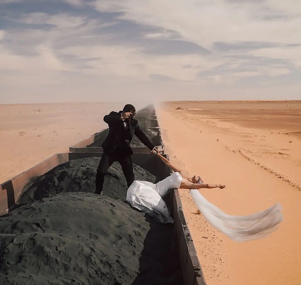 Wow: Kristijan Ilicic, 35, and his blogger wife Andrea Trgovcevic, 29, from Croatia, had the most extreme post-wedding photoshoot during their unconventional honeymoon to Mauritania in Northwest Africa. In one snap, Andrea hung over the moving train as Kristijan held onto her hand to pull her back