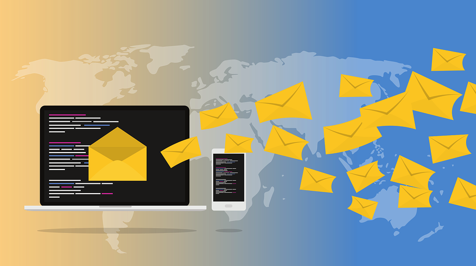 Image of a computer and mobile phone sending out letters across a world map background.