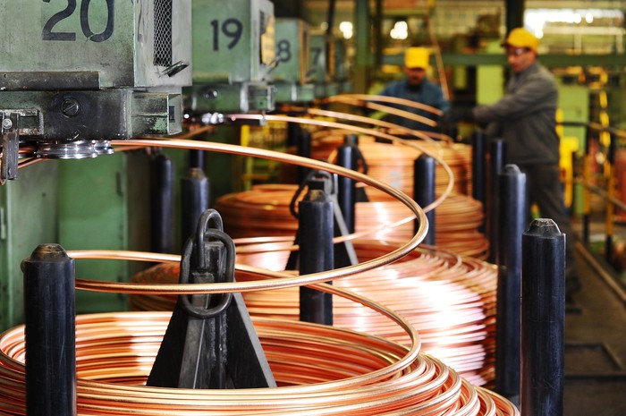 Copper tubing being produced in a factory.