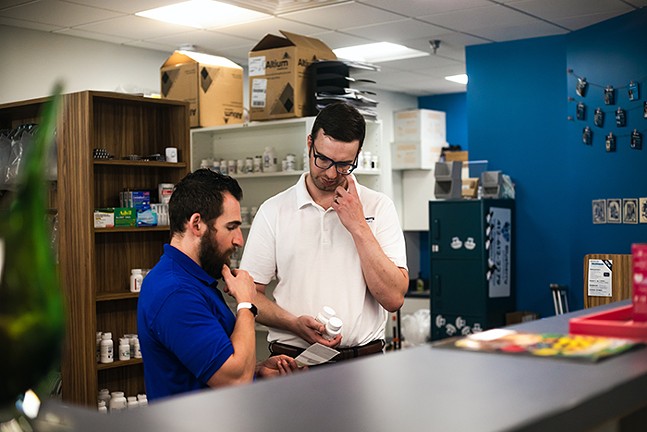 Pharmacist Kyle McCormick at work in Blueberry Pharmacy - CP PHOTO: RAYNI SHIRING