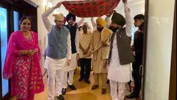 Punjab chief minister Bhagwant Mann (holding sword) being escorted by AAP leaders Arvind Kejriwal and MP Raghav Chadha for the wedding ceremony at his official residence in Chandigarh on Thursday as his sister Manpreet Kaur looks on. (HT Photo)