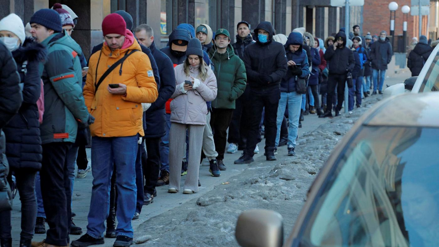 Sanctions are starting to impact the Russian economy. Pictured: Russians queue up to withdraw cash from an ATM in St Petersburg.© Reuters