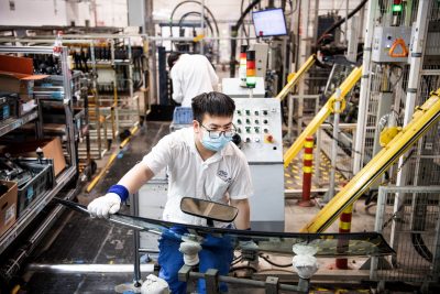 An employee wearing a mask works on a car assembly line at the SAIC General Motors Co. The SAIC General Motors Wuhan Branch has resumed production following epidemic prevention and control rules. The SAIC General Motors Wuhan Branch temporarily halted production by the suspension of supply chains as Shanghai lockdown, 9 July, 2022 (Photo: Ren Yong/SOPA Images/Sipa USA via Reuters).
