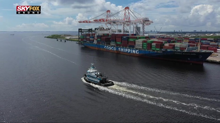 Small boat next to big boat at Port Tampa