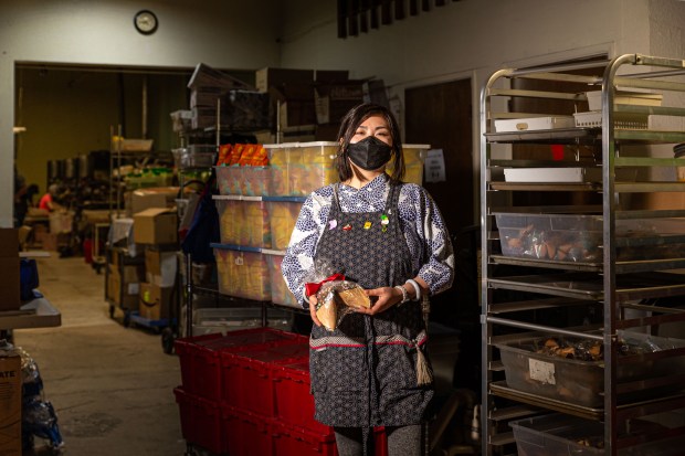 Alicia Wang, co-owner of Oakland Fortune Factory, makes custom, large-size fortune cookies as well as smaller cookies dipped in chocolate and sprinkled with sparkles and other toppings. (Wangyuxuan Xu/Bay Area News Group)