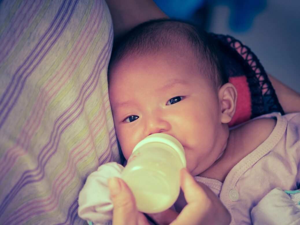 Baby drinking milk on mother's chest