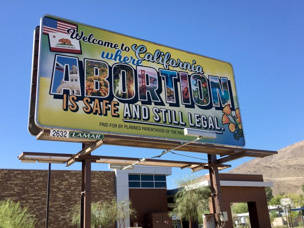 A billboard at the intersection of Highway 111 and Bob Hope Drive in Rancho Mirage, Calif. states "Welcome to California where abortion is safe and still legal." on Saturday, July 2, 2022. (Photo by Shelley Heffler)