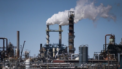 Smoke billows out of a power plant's chimney. 
