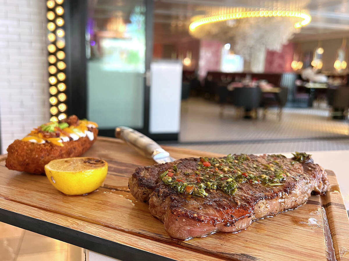 A 12-ounce New York strip steak comes with a loaded hashbrown at Sugar Factory American Brasserie at The Shops at Rivercenter on the San Antonio River Walk.