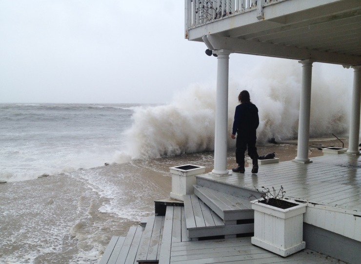 A wave crashes against the shore of a porch in Montauk.