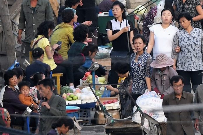 Street market in Hyesan, Ryanggang Province rice sellers dollar rate