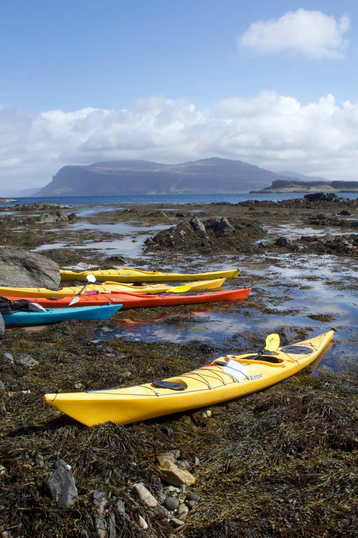 Kayaks on the Ross of Mull, with the Ardmeanach Peninsula and the summit of Ben More beyond