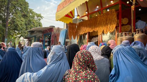 Women gather outside a bakery in Kabul, hoping for a handout from customers.