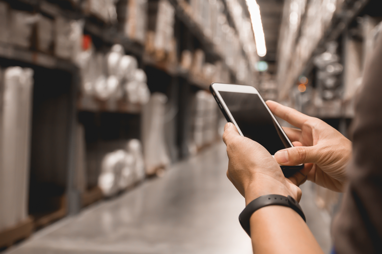 Person on phone in factory