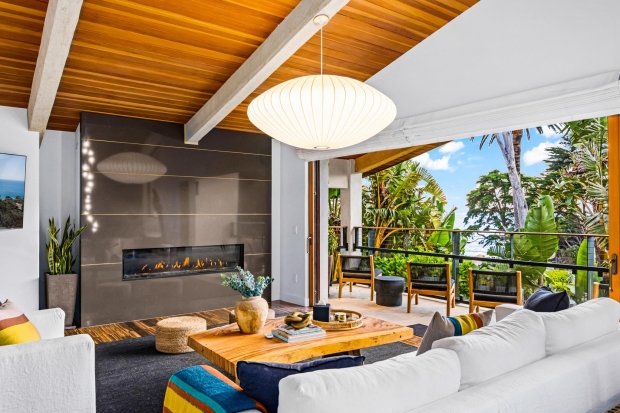 A gas fireplace anchors the living room in this modern...