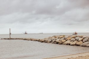 A work vessel exits the Murderkill River Inlet to support dredging operations in mid-August. DNREC's contractor Cottrell Contracting Corp. brought heavy equipment and support vessels in addition to the dredge and crews to complete the job.