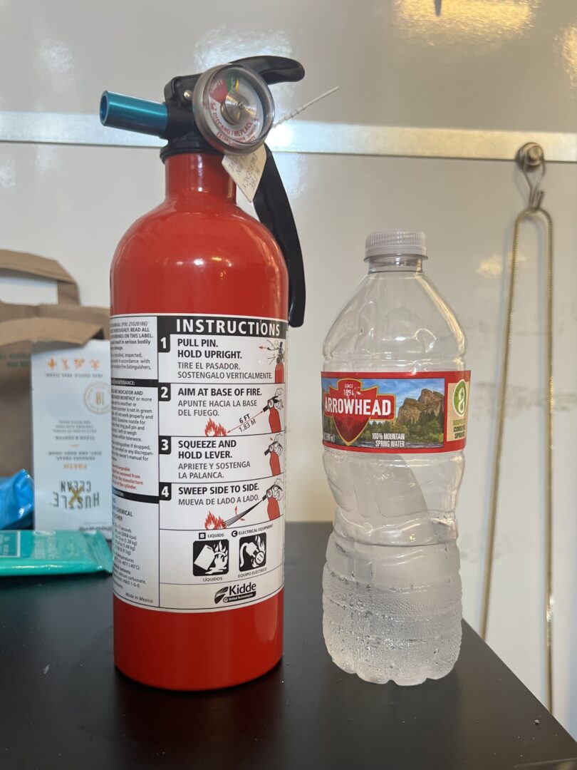 fire extinguisher next to water bottle for size. the fire extinguisher is barely bigger than the water bottle.