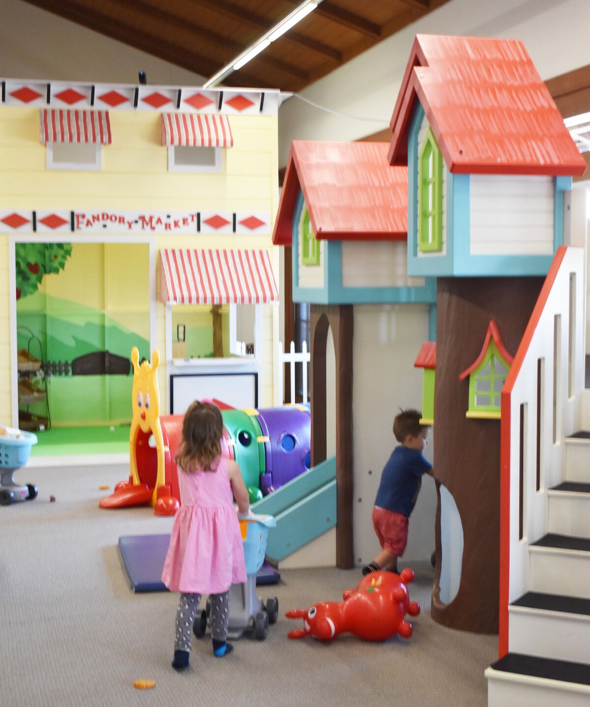 Toddlers playing in Fandory Factory’s indoor playground, which is set up to resemble a town.