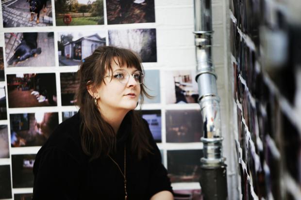 Oxford Mail: A woman looks at a 2019 exhibition of photographs taken by homeless people Picture: ED NIX