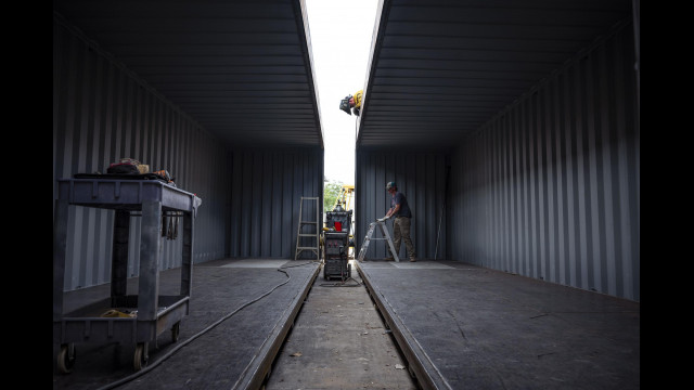Dan Caspi welds areas of a shipping container with Logan Woodburn at Maloy Mobile Storage in Albuquerque, N.M., on Tuesday, Sept. 13, 2022. Pat and Mary Beth Maloy established their business in 1988 and specialize in custom modifying and manufacturing storage containers for government and commercial use. (Chancey Bush/Albuquerque Journal)