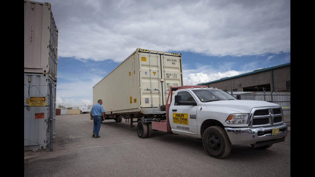 Pat Maloy checks a shipping container that is loaded onto a trailer at Maloy Mobile Storage in Albuquerque, N.M., on Tuesday, Sept. 13, 2022. Pat and Mary Beth Maloy established their business in 1988 and specialize in custom modifying and manufacturing storage containers for government and commercial use. (Chancey Bush/Albuquerque Journal)