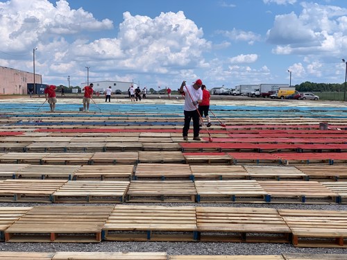Carolina Handling associates paint the tops of 2,500 wooden pallets that will be used to form the world's largest pallet painting. The Patriotic Pallet Project will be held on Oct. 10 in Greenville, South Carolina to recognize veterans and active-duty military personnel in Carolina Handling's Southeastern service area, and to raise awareness about the company's career opportunities that offer a meaningful military-to-civilian transition.