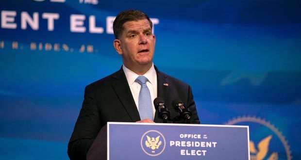Marty Walsh stands behind a lectern