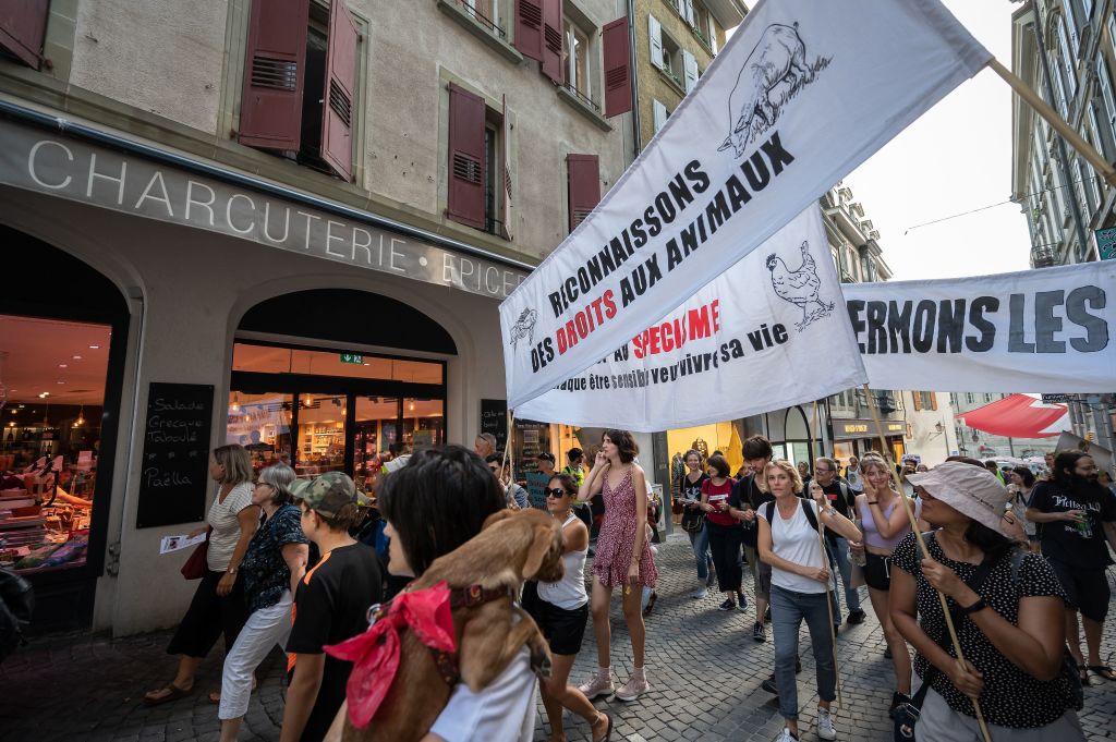 Activists hold a banner reading in French