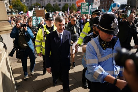Jacob Rees-Mogg escorted by police as he arrived at the Tory conference.