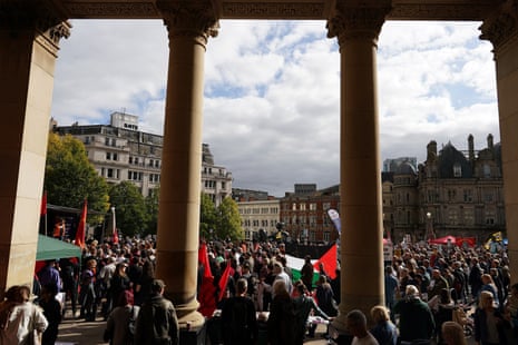 Protesters stand with placards as they take part in a protest at Victoria Square on the first day of the Tory conference.
