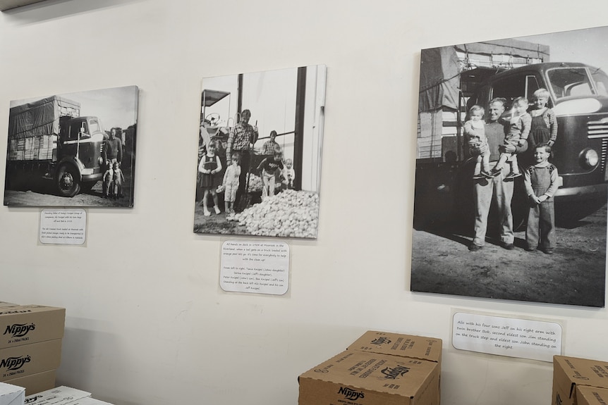 A wall with black and white photos of the Knispel family.
