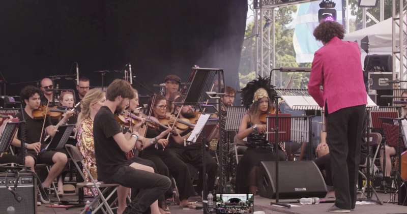 The orchestra performs 'Hebrides Redacted' at the 2022 Wilderness Festival, UK. Credit: Tom Besley Disappearing notes in classical tune highlight the dramatic loss of Humpback Whales