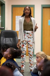Milford teacher Ashley Lockwood stands in front of her classroom teaching students.