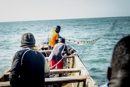 The crew pulling the net at the fishing ground.
