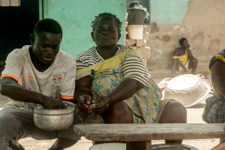 Fishmonger Ama Mensima and her grandson Kojo Kowaku clean fresh fish.