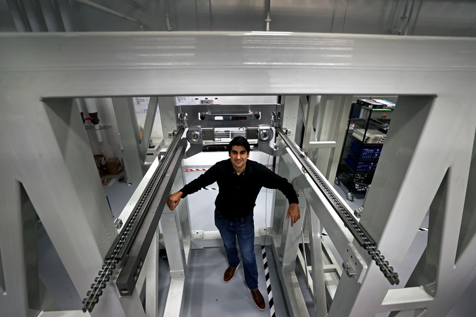 James DeMuth, CEO of Seurat Technologies, stands inside a product print chamber frame at the company's Wilmington headquarters.