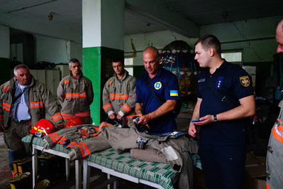 Ukrainian firefighters accept the donated supplies in Chernivtsi