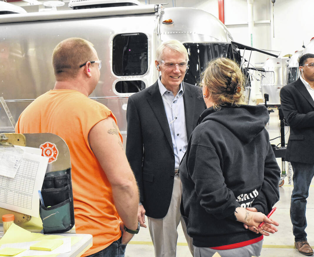Sen. Rob Portman listens to the concerns of Airstream employees on the assembly floor.