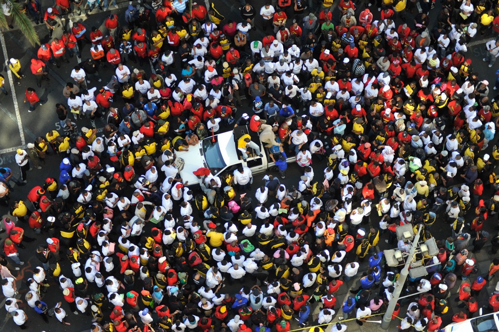 Members of the SA Transport and Allied Workers' Union and the United Transport and Allied Trade Union gather outside the Transnet Building in this file photo.